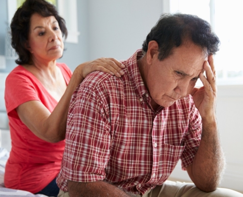 Wife Comforting Senior Resident With Dementia