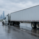 Chicago truck jackknife accident causes shown by a trailer angled across a wet city roadway