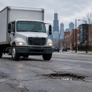 Chicago truck accident road defect liability scene with a truck near uneven pavement